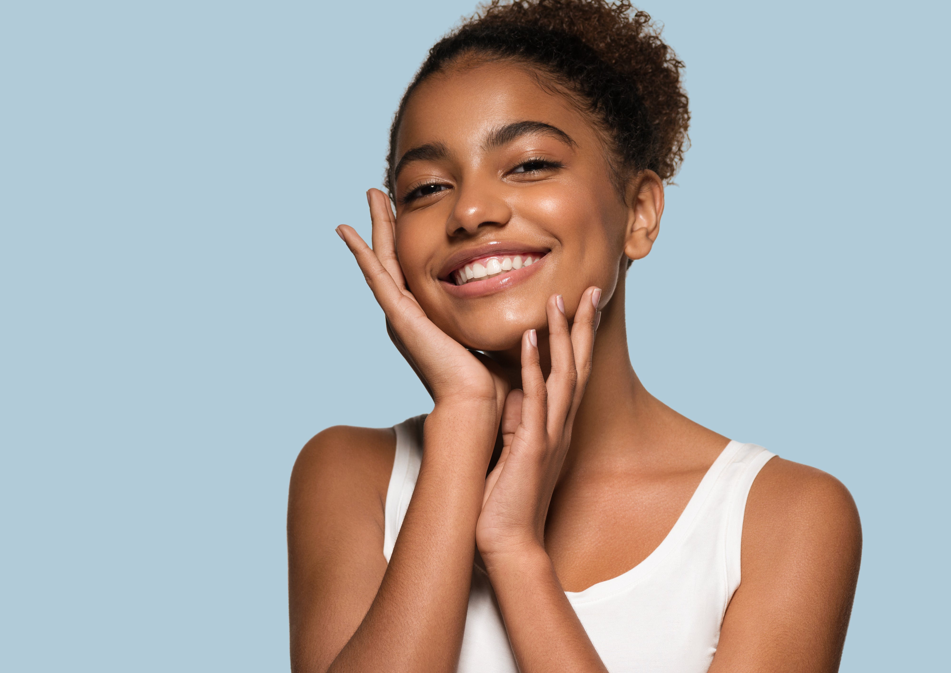 Woman with glowing, radiant skin after using Sensita - skincare products
